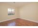 Inviting bedroom with hardwood floors, neutral walls, and a window overlooking the yard, creating a cozy, relaxing space at 36 Hunt Valley Trl, Henderson, NV 89052