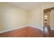 An empty bedroom with hardwood floors and light yellow walls offers a neutral, adaptable living space at 36 Hunt Valley Trl, Henderson, NV 89052