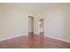 An empty bedroom with hardwood floors and light yellow walls offers a neutral, adaptable living space at 36 Hunt Valley Trl, Henderson, NV 89052