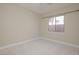 Empty bedroom with a window and neutral walls at 36 Hunt Valley Trl, Henderson, NV 89052