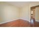 An empty bedroom with hardwood floors and light yellow walls offers a neutral, adaptable living space at 36 Hunt Valley Trl, Henderson, NV 89052