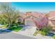 One story house with a two-car garage, landscaped yard, and mountain views at 36 Hunt Valley Trl, Henderson, NV 89052