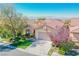 One story house with a two-car garage, landscaped yard, and mountain views at 36 Hunt Valley Trl, Henderson, NV 89052