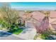 One story house with a two-car garage, landscaped yard, and mountain views at 36 Hunt Valley Trl, Henderson, NV 89052