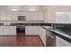 Spacious kitchen with stainless steel appliances and granite countertops at 36 Hunt Valley Trl, Henderson, NV 89052