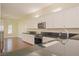 Bright kitchen with white cabinets, stainless appliances, and black granite counters at 36 Hunt Valley Trl, Henderson, NV 89052