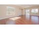 Spacious living room with hardwood floors and sliding glass doors to patio at 36 Hunt Valley Trl, Henderson, NV 89052