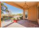 Inviting covered patio with elegant chandelier and views of the beautifully landscaped backyard at 36 Hunt Valley Trl, Henderson, NV 89052