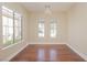 Bright room with large windows, hardwood floors, and neutral walls at 36 Hunt Valley Trl, Henderson, NV 89052