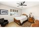 Bedroom with ceiling fan, wood bed frame and tiled floors at 3801 Terrace Grove St, Las Vegas, NV 89129