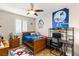 Bedroom with ceiling fan, wood bed frame, and work area at 3801 Terrace Grove St, Las Vegas, NV 89129