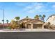 Single-story home with a three-car garage and desert landscaping at 3801 Terrace Grove St, Las Vegas, NV 89129