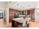 Granite island kitchen with dark wood cabinetry and tile flooring at 3801 Terrace Grove St, Las Vegas, NV 89129