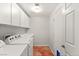 Bright laundry room with washer, dryer, and cabinets at 3801 Terrace Grove St, Las Vegas, NV 89129