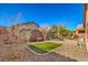 Artificial turf and gravel backyard with desert plants at 4039 Welsh Pony St, Las Vegas, NV 89122