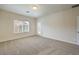 Bright bedroom with neutral carpet, large window and door to patio at 4039 Welsh Pony St, Las Vegas, NV 89122