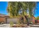 One-story house with a two-car garage and a tree in front at 4039 Welsh Pony St, Las Vegas, NV 89122