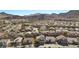 An aerial view of a suburban neighborhood nestled against a mountainous backdrop, emphasizing community living at 41 Voltaire Ave, Henderson, NV 89002