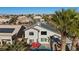 Aerial view of home and community with a sparkling pool, spa, and desert landscaping at 41 Voltaire Ave, Henderson, NV 89002