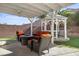 Backyard covered patio featuring outdoor furniture, with a view of the garden and landscape at 41 Voltaire Ave, Henderson, NV 89002