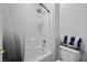 Bathroom with a shower-tub combination and tiled walls, featuring a neutral color palette at 41 Voltaire Ave, Henderson, NV 89002