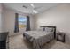 Bedroom with a neutral color scheme, featuring a queen bed and an arched window at 41 Voltaire Ave, Henderson, NV 89002