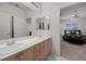 View of a bedroom with a double sink bathroom in the background at 41 Voltaire Ave, Henderson, NV 89002