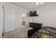 Cozy bedroom with a tv mounted on the wall and a view of the bathroom at 41 Voltaire Ave, Henderson, NV 89002