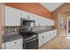 Bright kitchen with stainless steel appliances, granite countertops, and white cabinets at 41 Voltaire Ave, Henderson, NV 89002