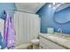 Bathroom with blue walls, granite vanity, and shower/tub combo at 451 Wright Way, Henderson, NV 89015