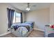 Bedroom with gray bed, wood flooring, and ceiling fan at 451 Wright Way, Henderson, NV 89015