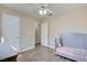 Bedroom with gray crib, wood flooring, and ceiling fan at 451 Wright Way, Henderson, NV 89015