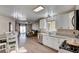 Open kitchen features granite counters, white cabinets, and a view to the living room at 451 Wright Way, Henderson, NV 89015