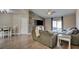 Open living room and dining area with wood-look floors and a rustic feature wall at 451 Wright Way, Henderson, NV 89015