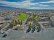 Aerial view of neighborhood featuring lush green spaces, mature trees, a playground, and mountain views at 4641 Sommerset Ct, Pahrump, NV 89061