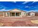 View of the home's backyard, featuring a covered patio and desert landscaping at 4641 Sommerset Ct, Pahrump, NV 89061