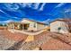 View of the home's backyard, featuring a covered patio and desert landscaping at 4641 Sommerset Ct, Pahrump, NV 89061