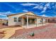 View of the home's backyard, featuring a covered patio and desert landscaping at 4641 Sommerset Ct, Pahrump, NV 89061