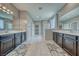 Bright bathroom featuring double sinks, walk-in shower, and tile floor at 4641 Sommerset Ct, Pahrump, NV 89061