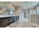 Bright bathroom featuring double sinks, walk-in shower, and tile floor at 4641 Sommerset Ct, Pahrump, NV 89061