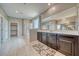 Bright bathroom featuring double sinks, walk-in shower, and tile floor at 4641 Sommerset Ct, Pahrump, NV 89061