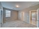 Bedroom with neutral carpet, window, walk in closet, and entry door and ensuite bathroom door at 4641 Sommerset Ct, Pahrump, NV 89061