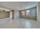 Bright dining room with tile flooring, a modern chandelier, and large windows overlooking the backyard at 4641 Sommerset Ct, Pahrump, NV 89061