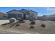 Charming house with gray two-car garage and nicely landscaped front yard at 4641 Sommerset Ct, Pahrump, NV 89061