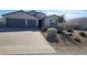 Two-story house with gray two-car garage, landscaping, and a paved driveway at 4641 Sommerset Ct, Pahrump, NV 89061