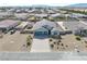 Aerial view of a desert home with a long drive, three car garage, and low maintenance landscaping at 4641 Sommerset Ct, Pahrump, NV 89061