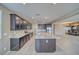 Modern kitchen with stainless steel appliances, granite countertops, and a large island with barstool seating at 4641 Sommerset Ct, Pahrump, NV 89061