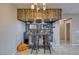 Custom wet bar area with wood accents, bar seating, and display shelving for glassware and decor at 4641 Sommerset Ct, Pahrump, NV 89061