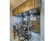 A stylish wet bar featuring custom wood paneling, a mirrored backsplash, and bar stool seating at 4641 Sommerset Ct, Pahrump, NV 89061