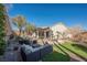 Large backyard with patio, seating area, and lush landscaping at 493 Lace Haven Ct, Henderson, NV 89012